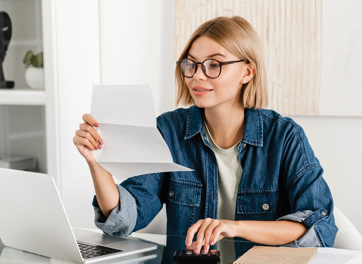 Person Looking at Bank Statement and Bill